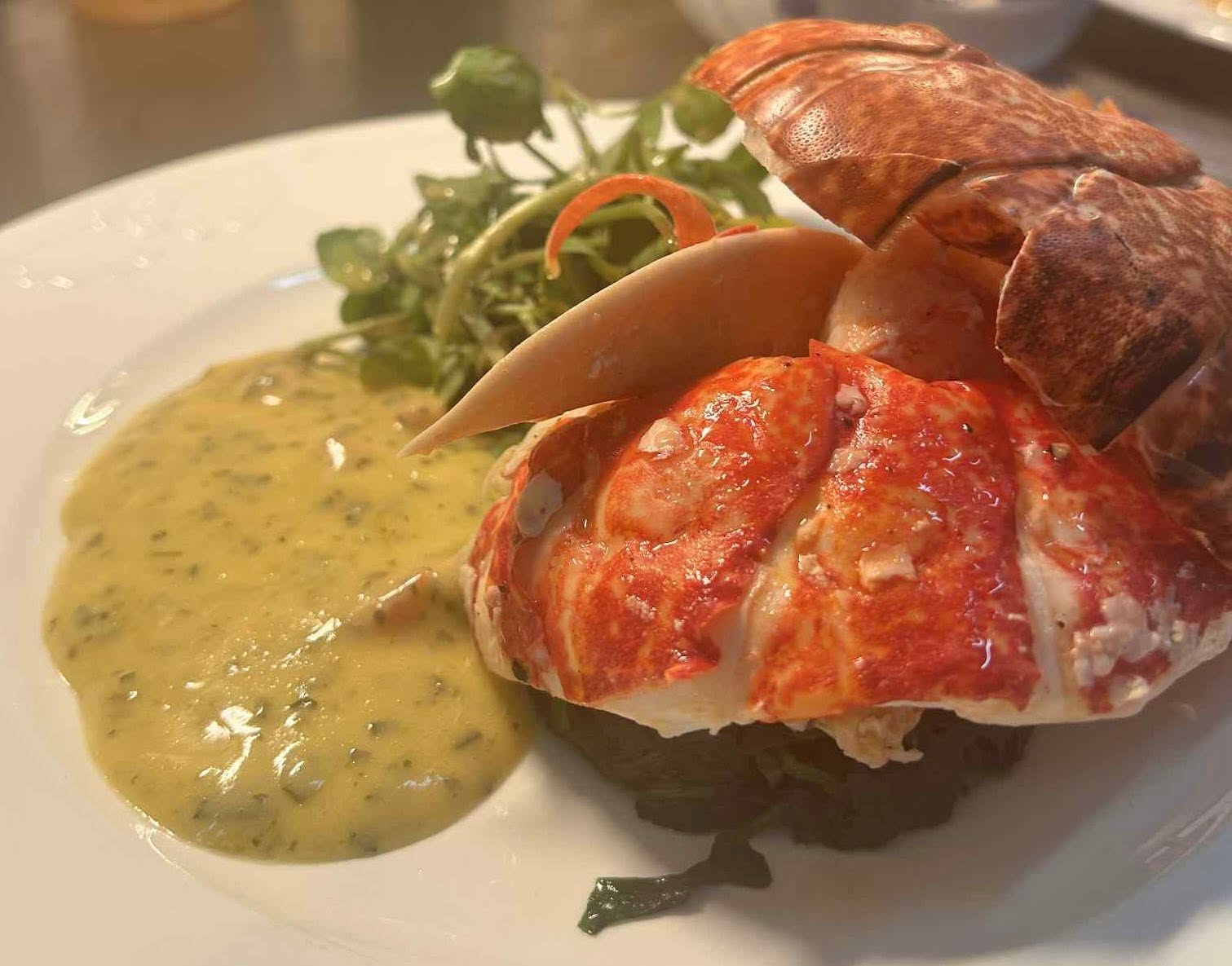 Half lobster with watercress and a herb butter sauce